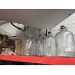 A mixed lot of glassware including large Bells whiskey bottle, seven demi-johns and a glass puch