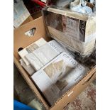 A box containing curtains, bed linen - all in original packaging