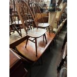 A vintage Ercol elm drop leaf table and five Ercol 'Quaker' chairs.