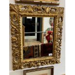 An Italian carved gilt wood mirror, 17th/18th century with later elements, 51.5cm x 60cm.