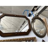 An oval gilt framed mirror and an oak framed mirror.