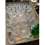 A box of wine glasses, tumblers, water jug, and hand blown green glass jug