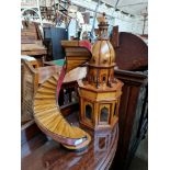 Two wooden models; a spiral staircase and an Islamic style building.