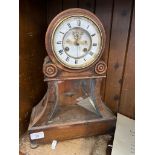 A vintage French oak cased mantle clock with pendulum and key.