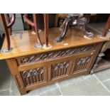 An oak coffer with Gothic style carved panels.