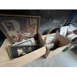 Two boxes of pictures, advertising, Art Deco picture holders, needlework, picture frames, etc.