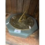 A brass sundial on a Cumbrian slate base,
