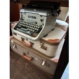 Two vintage cases and an Imperial 66 typewriter.