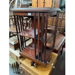 An Edwardian inlaid mahogany revolving bookcase.