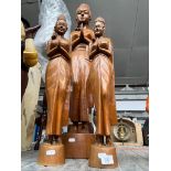 Three Eastern carved wood figures.