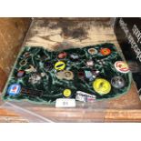 A cloth containing appx 25 metal badges, mainly relating to motoring, including Rolls Royce,