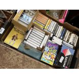 Two boxes containing cassette tapes and a vintage Otake cassette recorder.
