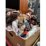 A box of various dolls.