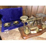 A set of Post Office scales with weights, and a cased brass balances with weights and tweezers