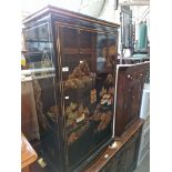 A Chinese black lacquer and gilt decorated side cabinet.