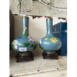 A pair of cloisonne vases, bulbous shape with long stem neck, blue ground with floral decoration,