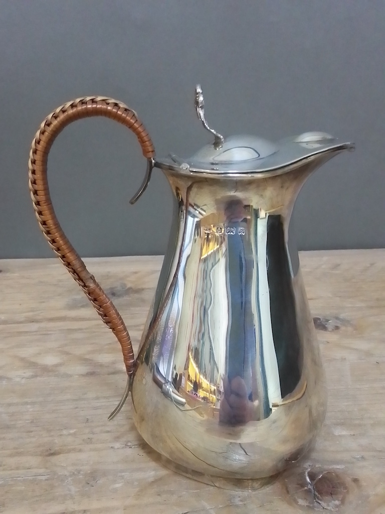 An Edward VII silver lidded jug with rattan bound handle, George Unite, Birmingham 1904, height