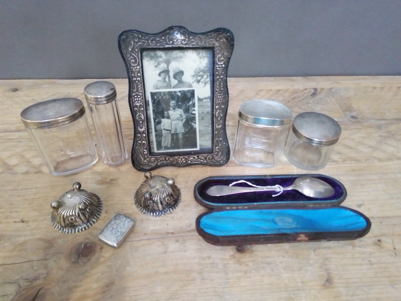 A mixed lot of hallmarked silver comprising a photo frame, four topped glass jars, a cased spoon,