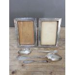 A mixed lot of hallmarked silver comprising a pair of photo frames, a 'berry' spoon, another
