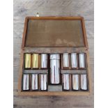 A silver plated novelty cased drinking set comprising flask and 12 shot glasses modelled as