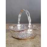 An Elizabeth II pierced silver bon bon dish with swing handle, C J Vander Ltd, Sheffield 2001,