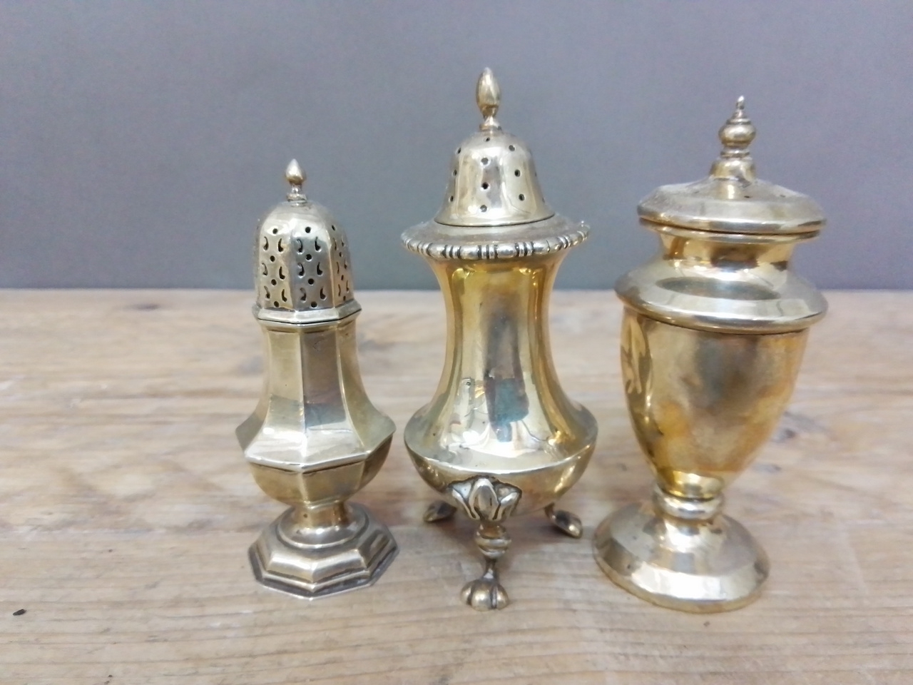 A group of three hallmarked silver pepper pots, various dates and makers, wt. 4ozt.