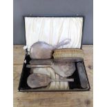 An Art Deco cased hallmarked silver dressing table set, two further brushes and a mirror.