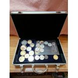 A coin collecting case containing assorted coins to include gold plated & commemorative crowns etc.