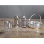Assorted hallmarked silver comprising a swing basket, two pepper pots and a napkin ring, silver