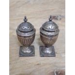 A pair of hallmarked silver pepper pots, wt. 1 3/4ozt.