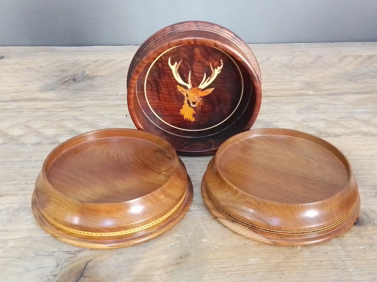 A pair Peter Hall & Son inlaid walnut wine coasters and another inlaid with a stag, diam. 13cm &