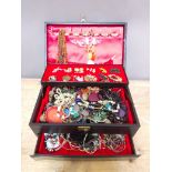 A box of assorted costume jewellery.