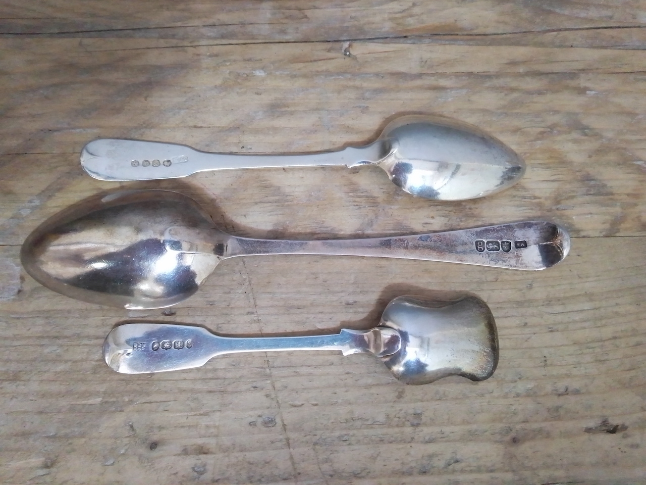 A group of three silver spoons comprising a George III desert spoon by Stephen Adams II London 1782,