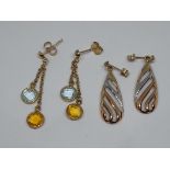 Two pairs of earrings comrpising a pair set with citrine and blue topaz marked '9k' and another pair