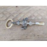 A George V silver rattle with mother of pearl handle and bone ring, Crisford & Norris Ltd ,