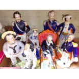 A group of eight Staffordshire pottery figures.