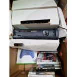 A box containing an Xbox 360, Xbox wireless controller, assorted 360 games, assorted PS3 games & a