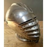 A Victorian reproduction of a German Maximilian style helmet with hinged up visor and side plates.