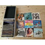 A hard aluminium case containing various vinyl singles to include John Lennon, Queen, Abba, etc.