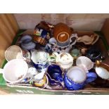A box of assorted pottery mugs and jugs.