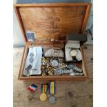A wooden box containing various items of militaria and collectables including King's Regiment silver