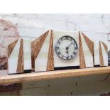 An Art Deco marble mantle clock with garnitures.