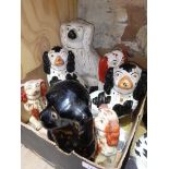 A box of 19th century Staffordshire pottery dogs.