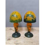 A pair of reproduction Galle style mushroom lamps, in orange and green and decorated with