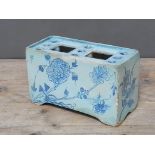 An English 18th century delft flower brick, length 20cm. Condition - various losses to glaze, old