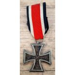 A German WWII Iron Cross, 2nd class, marked 1939. Possible mark on suspension ring. We believe