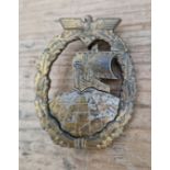 A German WWII Kriegsmarine Auxiliary Cruiser War badge, riveted globe. Unmarked, loss of gilt in