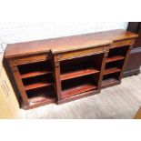 A late Regency or George IV mahogany bookcase, breakfront with reeded edge, three frieze drawers,