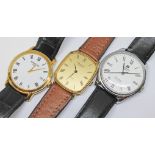 A group of three modern gent's watches comprising two Raymond Weil gild plated watches and a