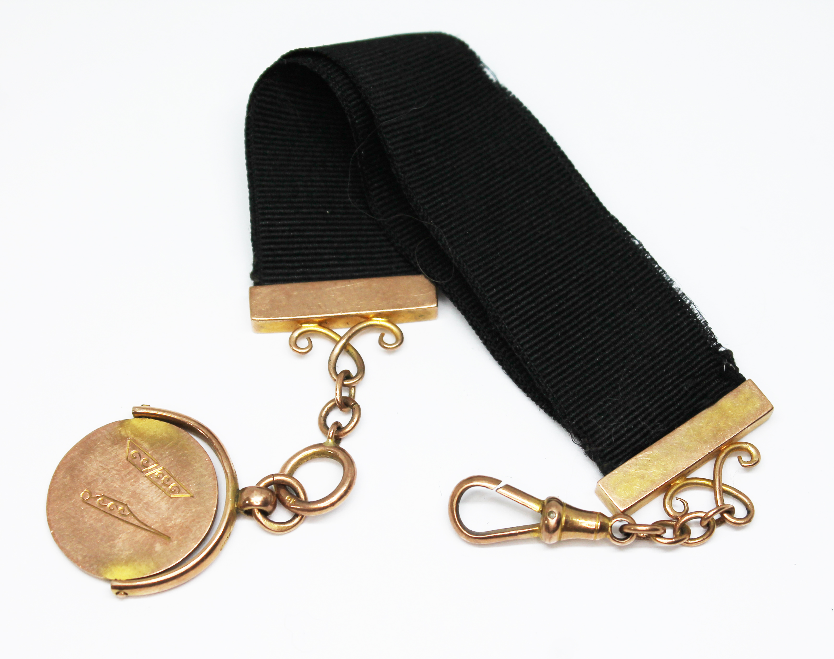 A Masonic ribbon fob, marked '9ct', maker's initials 'R.J', length 18cm, gross wt. 8.2g.